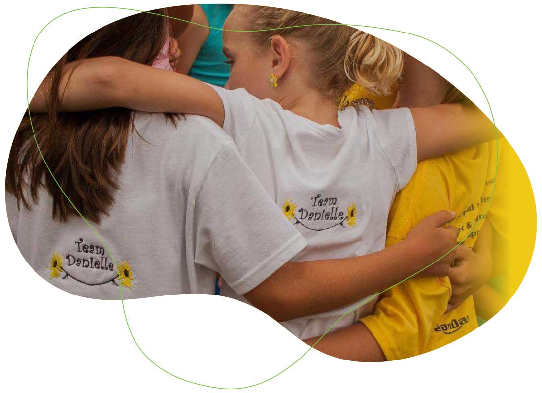 Young girls arm-in-arm at an event